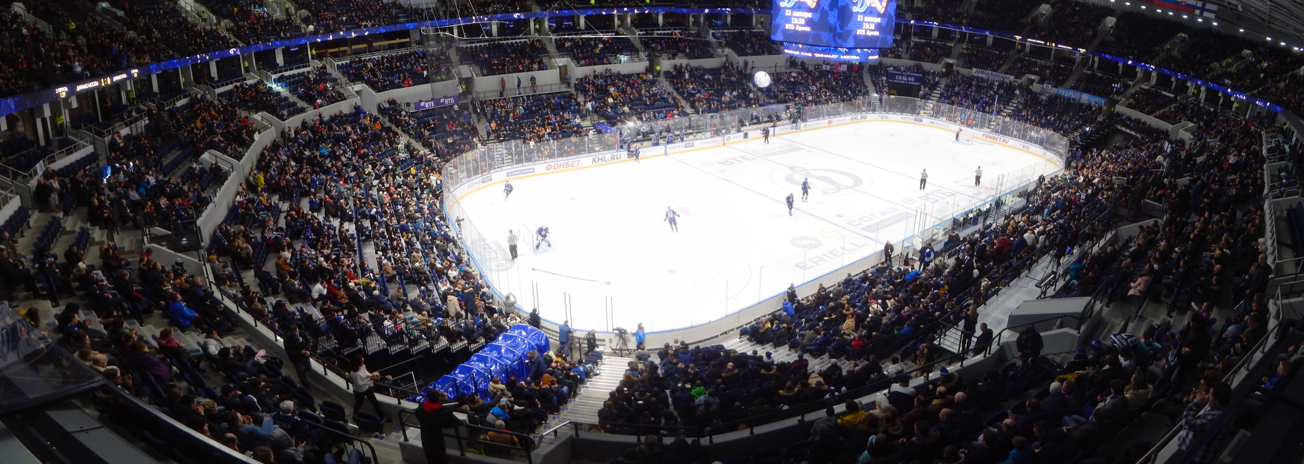 Panoramic view of an ice hockey game with packed spectator stands